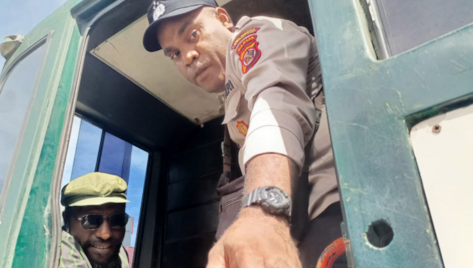 Jayapura court finds Yeimo guilty of ‘treason’ in appeal – longer sentence Victor Yeimo (seated and wearing glasses), in a detention vehicle after attending a treason trial at Jayapura District Court, on 4 July 2023