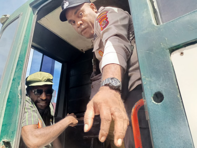 Viktor Yeimo TJ 680wide Victor Yeimo (seated and wearing glasses), in a detention vehicle after attending a treason trial at Jayapura District Court, on 4 July 2023