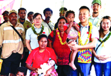 Dr Liu (second from right) visits baby Taylor (cradled by his mother)