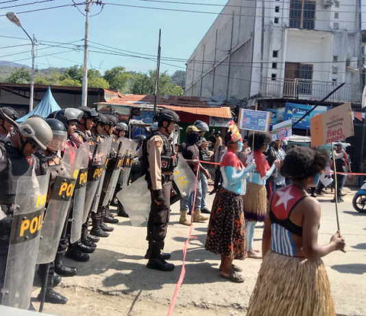 Women protesters daubed in the colours of the Morning Star flag of West Papuan independence