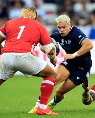 Scotland's wing Darcy Graham is tackled by Tonga's tighthead prop Ben Tameifuna during the Rugby World Cup