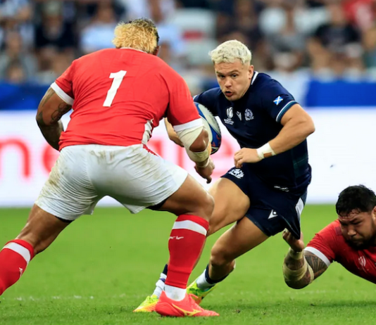 Scotland's wing Darcy Graham is tackled by Tonga's tighthead prop Ben Tameifuna during the Rugby World Cup
