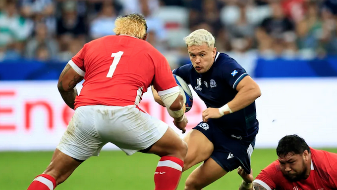 Scotland's wing Darcy Graham is tackled by Tonga's tighthead prop Ben Tameifuna during the Rugby World Cup
