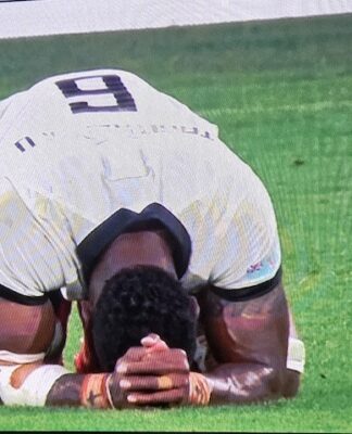 Prayers of elation . . . a jubilant Fiji after beating Australia 22-15