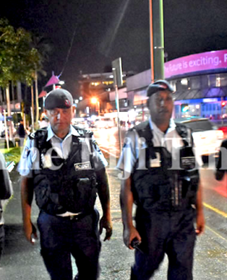 Fiji police officers Corporal Gerry McGoon (on left) and PC Sevania Manulevu on foot patrol along Victoria Parade in Suva