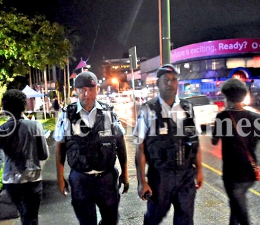 Fiji police officers Corporal Gerry McGoon (on left) and PC Sevania Manulevu on foot patrol along Victoria Parade in Suva