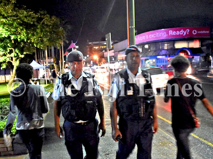 Fiji police officers Corporal Gerry McGoon (on left) and PC Sevania Manulevu on foot patrol along Victoria Parade in Suva
