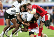 Fiji's Semi Radradra and Waisea Nayacalevu with Nick Tompkins of Wales