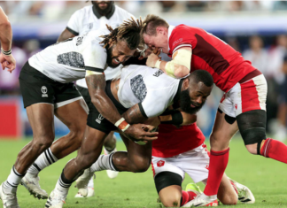 Fiji's Semi Radradra and Waisea Nayacalevu with Nick Tompkins of Wales