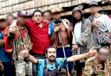 The controversial photo of Milne Bay Governor Gordon Wesley (red shirt) and gang leader Eugene Pakailasi (blue shirt)