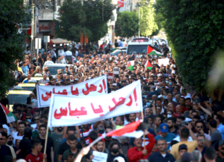 Palestinian demonstrators protesting in Ramallah in the Occupied West Bank against Palestine President Mahmoud Abbas in the aftermath of the death of activist Nizar Banat