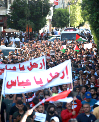 Palestinian demonstrators protesting in Ramallah in the Occupied West Bank against Palestine President Mahmoud Abbas in the aftermath of the death of activist Nizar Banat