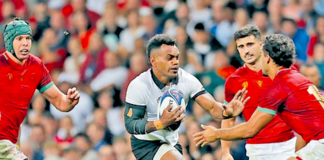 Flying Fijians fullback Sireli Maqala tries to dance his way through the Portugese defence