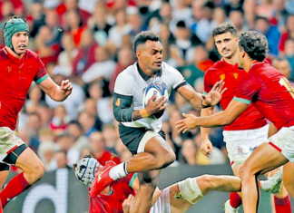 Flying Fijians fullback Sireli Maqala tries to dance his way through the Portugese defence