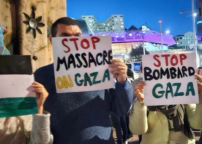"Stop massacre on Gaza" placards abound at last night's candlelight vigil in Auckland