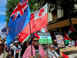 Pro-Palestinian protesters carrying the Fiji and Tongan national flags