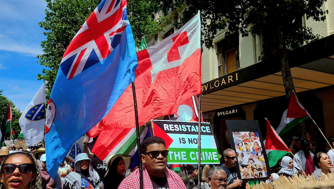 Pro-Palestinian protesters carrying the Fiji and Tongan national flags