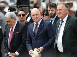 New Zealand Prime Minister Christopher Luxon (centre) flanked