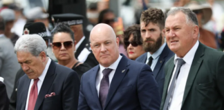 New Zealand Prime Minister Christopher Luxon (centre) flanked
