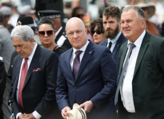 New Zealand Prime Minister Christopher Luxon (centre) flanked