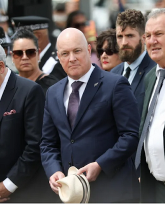 New Zealand Prime Minister Christopher Luxon (centre) flanked