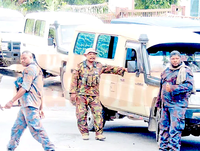 PNG riot police and Defence Force officers on duty