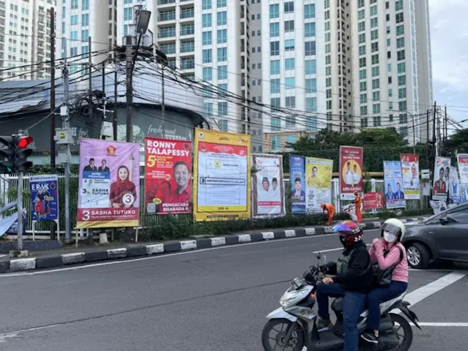 Political campaign posters from many politicians displayed on a street in Jakarta, Indonesia