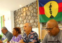 Pro-independence Union Calédonienne's spokesman Gilbert Tyuienon (centre) speaks to the media