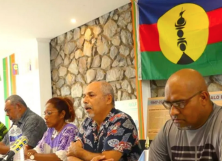 Pro-independence Union Calédonienne's spokesman Gilbert Tyuienon (centre) speaks to the media