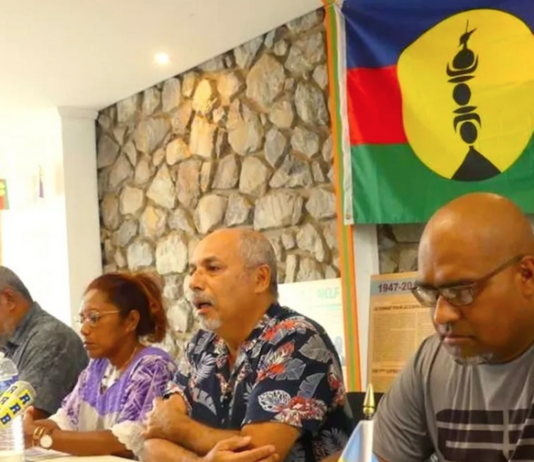 Pro-independence Union Calédonienne's spokesman Gilbert Tyuienon (centre) speaks to the media