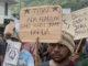 West Papuan demonstrators carry posters depicting torture