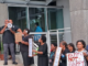 Frustrated employees of the University of the South Pacific dressed in black