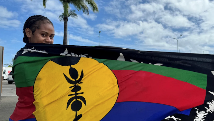 Pro-independence activist issues dire warning to France over Kanaky New Caledonia A woman wrapped in Kanak flag of independence with pride