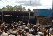 Indonesian police disperse Papuan demonstrators at the gate of the Jayapura University of Science and Technology
