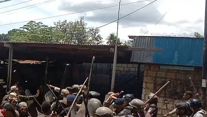 Indonesian police disperse Papuan demonstrators at the gate of the Jayapura University of Science and Technology