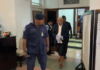 Former Fiji prime minister Voreqe Bainimarama walks out of the Suva High Court escorted by police officers to the be taken to jail today.