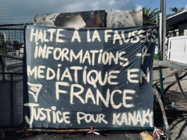 A message to the news media among the charred Nouméa protest debris