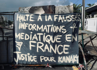 A message to the news media among the charred Nouméa protest debris