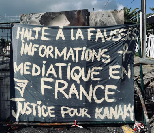 A message to the news media among the charred Nouméa protest debris