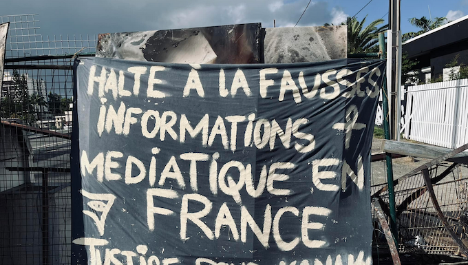 A message to the news media among the charred Nouméa protest debris