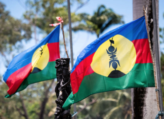 Flags of an independent Kanaky fly at a barricade near Nouméa