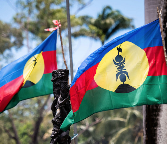 Flags of an independent Kanaky fly at a barricade near Nouméa