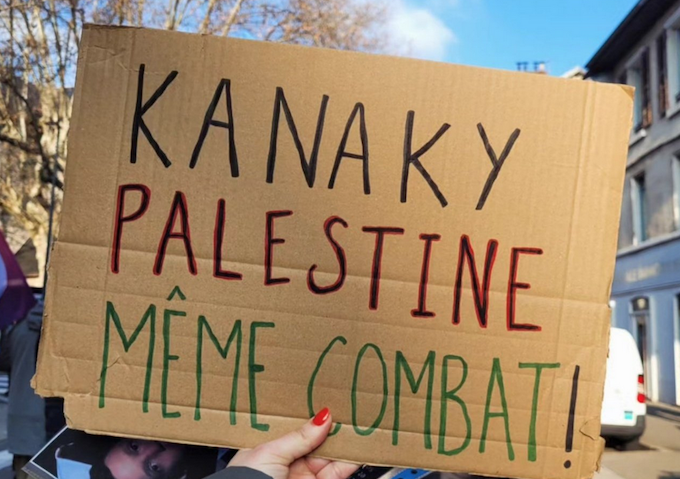 "Kanaky Palestine - same combat" solidarity placard.