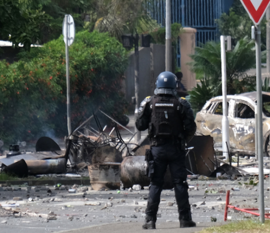 A French policeman on guard in a Nouméa street