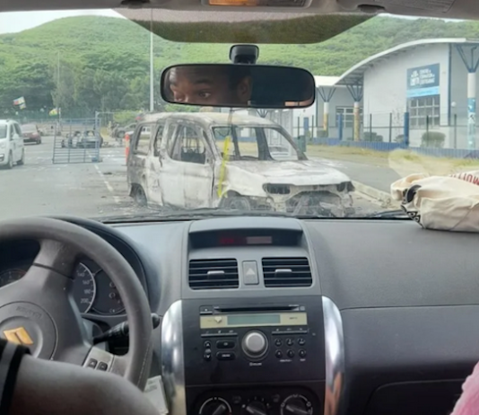 The burnt out remains of a car seen near the University of Caledonia