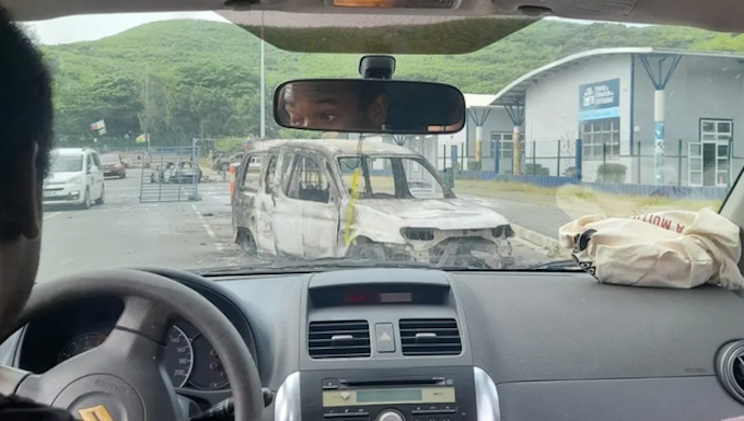 The burnt out remains of a car seen near the University of Caledonia