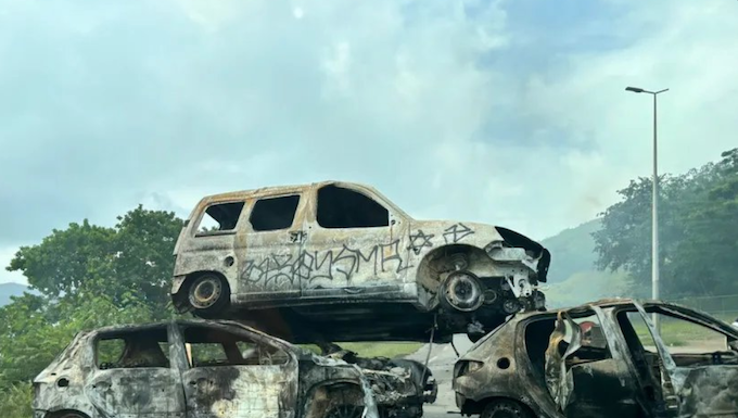 Piled up . . . burnt out cars block a road near Nouméa