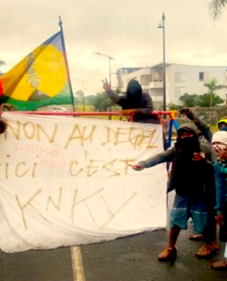 A Kanak pro-independence protester banner declares "No to 'unfreezing' (the electoral rules)"