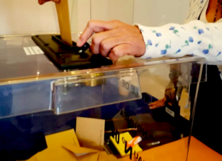 A New Caledonian resident places a vote at a ballot box in Nouméa