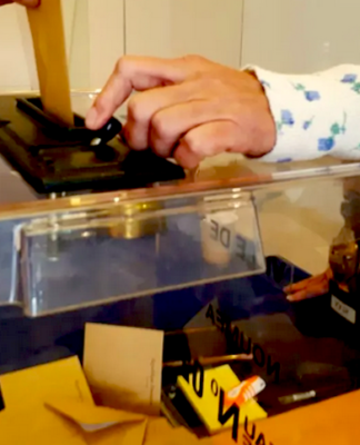 A New Caledonian resident places a vote at a ballot box in Nouméa